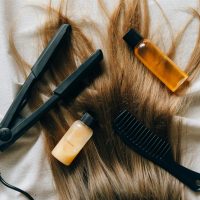 Aesthetic flat lay of hair products and tools for styling and grooming.